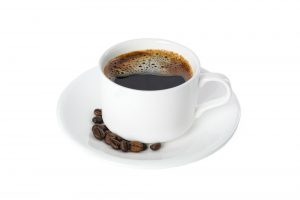 Cup of coffee with coffee beans isolated on white background. Coffee time accessories